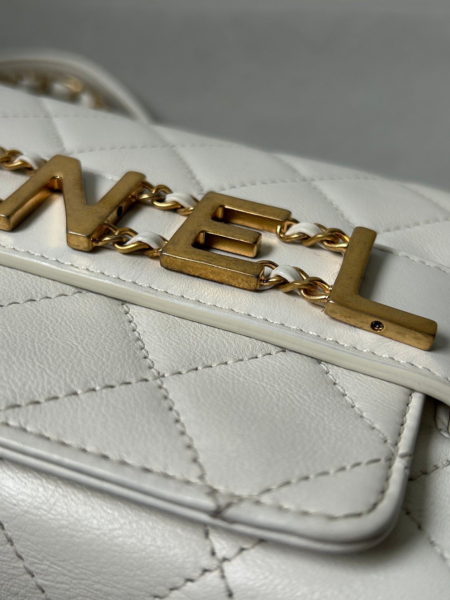 Chanel logo enchained flap bag quilted lambskin