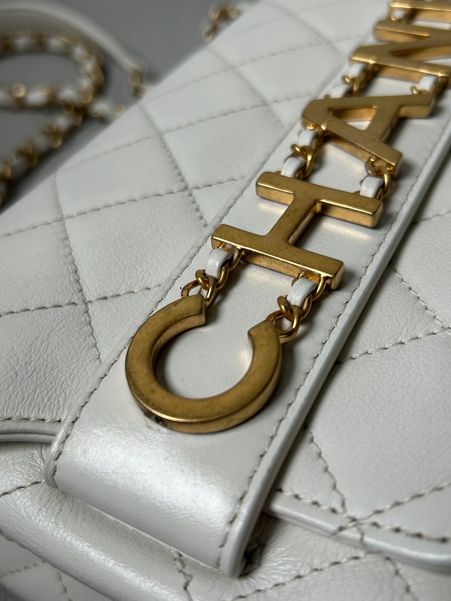 Chanel logo enchained flap bag quilted lambskin